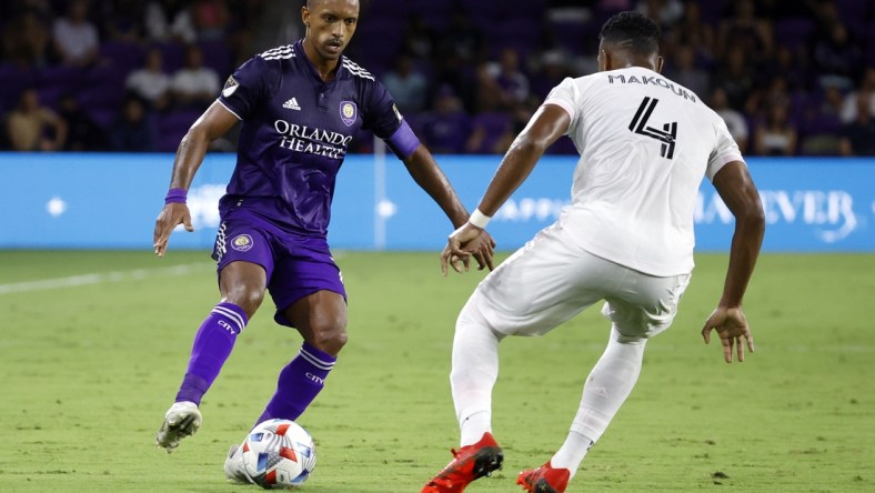 Aug 4, 2021; Orlando, Florida, USA; Orlando City SC forward Nani (17) dribbles the ball as Inter Miami CF defender Christian Makoun (4) defends during the first half at Orlando City Stadium. Mandatory Credit: Kim Klement-USA TODAY Sports