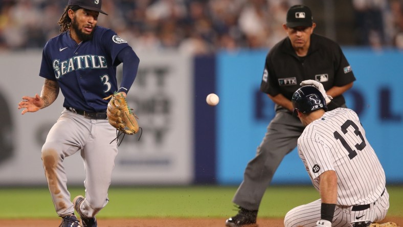 Aug 5, 2021; Bronx, New York, USA; New York Yankees left fielder Joey Gallo (13) slides into second base with a double before Seattle Mariners shortstop J.P. Crawford (3) receives the throw during the fourth inning at Yankee Stadium. Mandatory Credit: Brad Penner-USA TODAY Sports