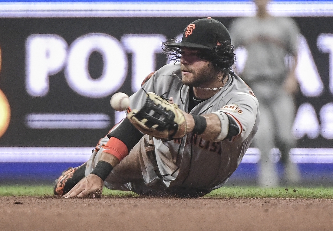 Aug 7, 2021; Milwaukee, Wisconsin, USA;  San Francisco Giants shortstop Brandon Crawford (35) attempts to make a force out on an infield hit by Milwaukee Brewers center fielder Lorenzo Cain (not pictured) in the second inning at American Family Field. Mandatory Credit: Benny Sieu-USA TODAY Sports