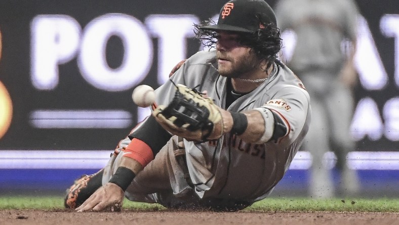 Aug 7, 2021; Milwaukee, Wisconsin, USA;  San Francisco Giants shortstop Brandon Crawford (35) attempts to make a force out on an infield hit by Milwaukee Brewers center fielder Lorenzo Cain (not pictured) in the second inning at American Family Field. Mandatory Credit: Benny Sieu-USA TODAY Sports