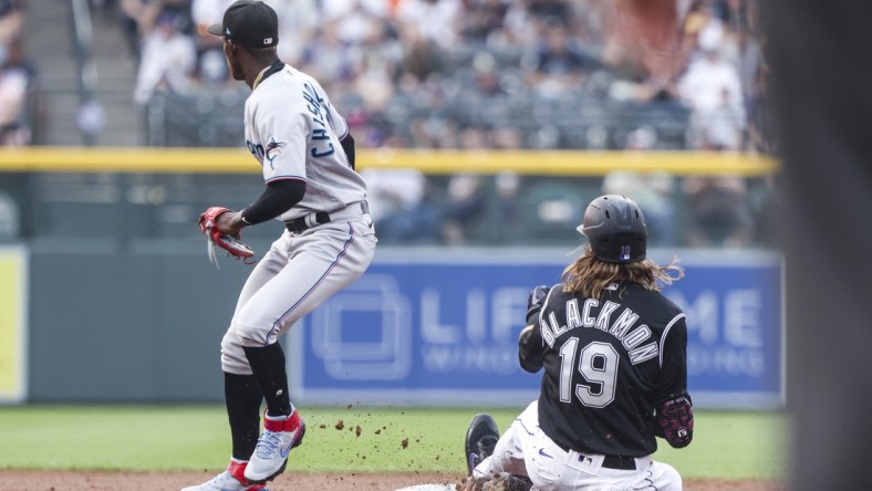 Aug 7, 2021; Denver, Colorado, USA; Colorado Rockies right fielder Charlie Blackmon (19) slides safely into second base past Miami Marlins second baseman Jazz Chisholm Jr. (2) after hitting a double in the second inning at Coors Field. Mandatory Credit: Michael Ciaglo-USA TODAY Sports