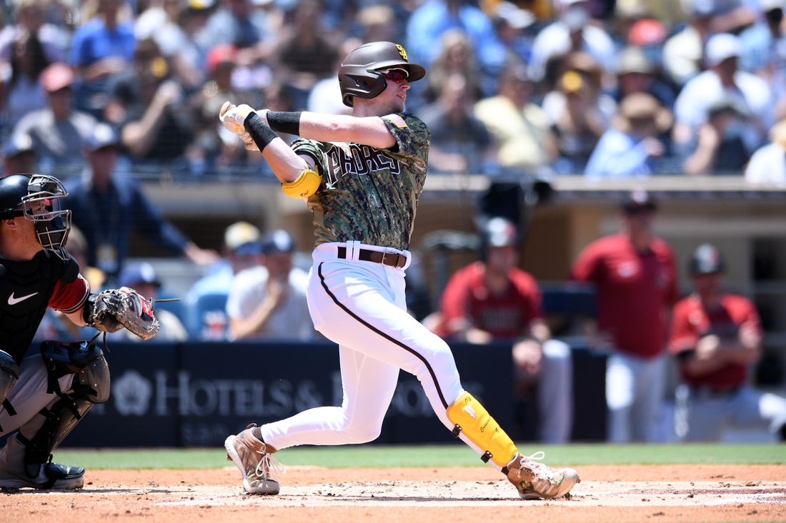 Aug 8, 2021; San Diego, California, USA; San Diego Padres shortstop Jake Cronenworth (9) hits an RBI single against the Arizona Diamondbacks during the first inning at Petco Park. Mandatory Credit: Orlando Ramirez-USA TODAY Sports