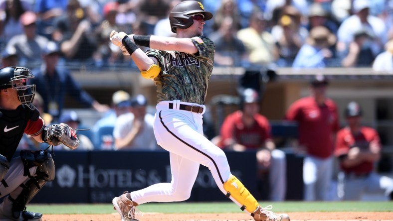 Aug 8, 2021; San Diego, California, USA; San Diego Padres shortstop Jake Cronenworth (9) hits an RBI single against the Arizona Diamondbacks during the first inning at Petco Park. Mandatory Credit: Orlando Ramirez-USA TODAY Sports