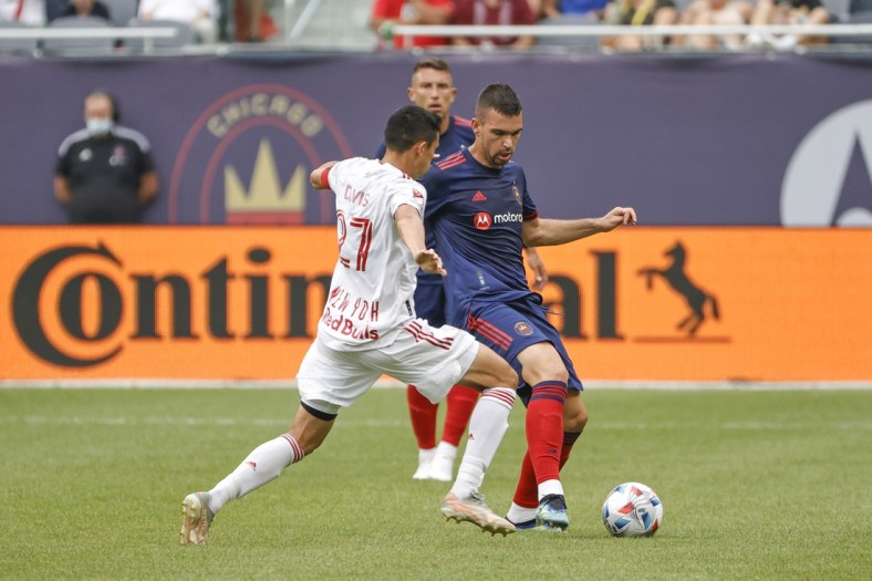 Aug 8, 2021; Chicago, Illinois, USA; Chicago Fire midfielder Luka Stojanovic (8) is defended by New York Red Bulls midfielder Sean Davis (27) during the first half of a MLS game at Soldier Field. Mandatory Credit: Kamil Krzaczynski-USA TODAY Sports