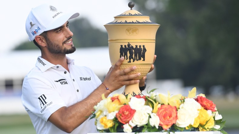 Aug 8, 2021; Memphis, Tennessee, USA, Abraham Ancer poses with the Gary Player Cup after winning WGC FedEx St. Jude Invitational golf tournament at TPC Southwind in a two hole playoff. Mandatory Credit: Christopher Hanewinckel-USA TODAY Sports