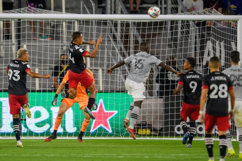 Aug 8, 2021; Washington, DC, Washington, DC, USA;  D.C. United midfielder Andy Najar (14) heads the ball into the net for a goal against the CF Montr al during the first half at Audi Field. Mandatory Credit: Rafael Suanes-USA TODAY Sports