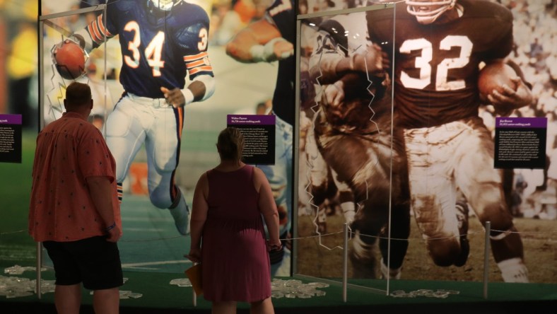 Fans look at the photo display in the HOF museum the Pro Football Hall of Fame Enshrinement ceremony Sunday, Aug. 8, 2021 at Tom Benson Hall of Fame Stadium in Canton, Ohio.

Hof Calvin