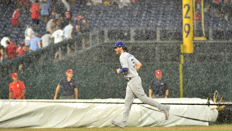 Aug 10, 2021; Philadelphia, Pennsylvania, USA; Los Angeles Dodgers center fielder Cody Bellinger (35) runs off the field during rain delay in the fourth inning against the Philadelphia Phillies at Citizens Bank Park. Mandatory Credit: Eric Hartline-USA TODAY Sports