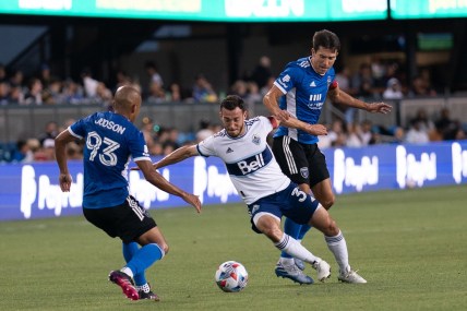 Aug 13, 2021; San Jose, California, USA; Vancouver Whitecaps midfielder Russell Teibert (31) fights for control of the ball against San Jose Earthquakes midfielder Judson (93) and defender Tanner Beason (15) during the first half at PayPal Park. Mandatory Credit: Stan Szeto-USA TODAY Sports