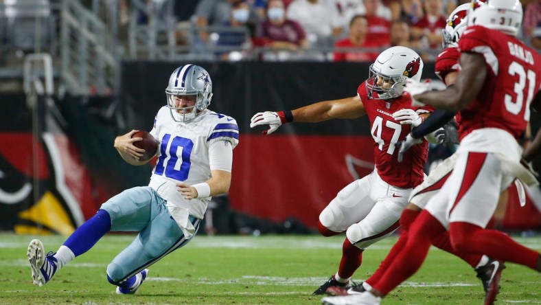 August 13, 2021; Glendale, Arizona, USA; Cowboys' Cooper Rush (10) slides down against Cardinals' Ezekiel Turner (47) during the third quarter at the State Farm Stadium in Glendale. Patrick Breen-The Republic

Nfl Preseason Cardinals Vs Cowboys