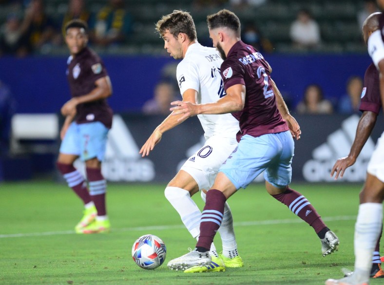 Aug 17, 2021; Carson, California, USA; Los Angeles Galaxy forward Nick DePuy (20) controls the ball against Colorado Rapids defender Keegan Rosenberry (2) during the first half at Dignity Health Sports Park. Mandatory Credit: Gary A. Vasquez-USA TODAY Sports