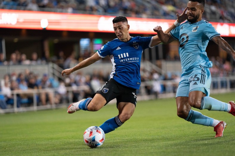 Aug 17, 2021; San Jose, California, USA;  Minnesota United defender D.J. Taylor (26) attempts to defend against San Jose Earthquakes forward Cristian Espinoza (10) during the first half at PayPal Park. Mandatory Credit: Stan Szeto-USA TODAY Sports