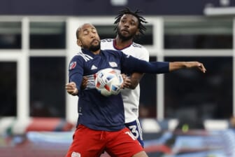 Aug 18, 2021; Foxborough, Massachusetts, USA; New England Revolution forward Teal Bunbury (10) tries to keep D.C. United defender Chris Odoi-Atsem (3) from the ball during the first half at Gillette Stadium. Mandatory Credit: Winslow Townson-USA TODAY Sports