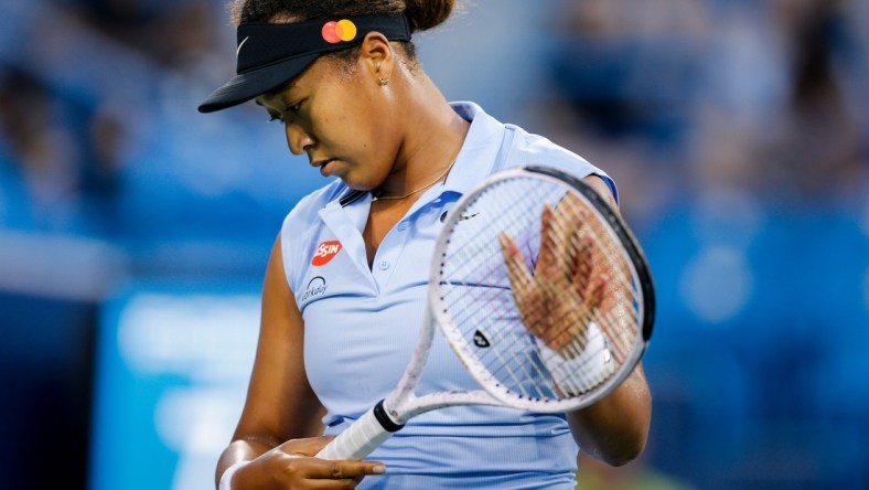 Naomi Osaka prepares to return a serve during a match between Jill Teichmann (SUI) and Naomi Osaka (JPN) in the Western & Southern Open at the Lindner Family Tennis Center in Mason, Ohio on Thursday, Aug. 19, 2021. Teichmann won 3-6, 6-3, 6-3.