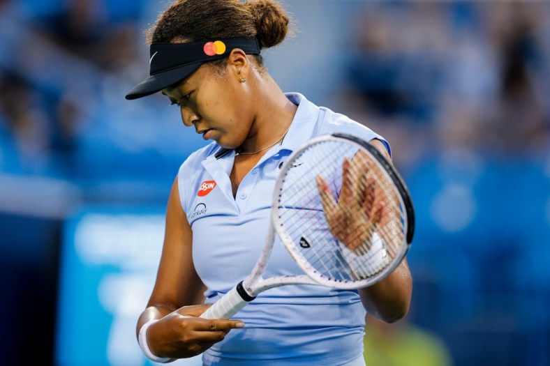 Naomi Osaka prepares to return a serve during a match between Jill Teichmann (SUI) and Naomi Osaka (JPN) in the Western & Southern Open at the Lindner Family Tennis Center in Mason, Ohio on Thursday, Aug. 19, 2021. Teichmann won 3-6, 6-3, 6-3.
