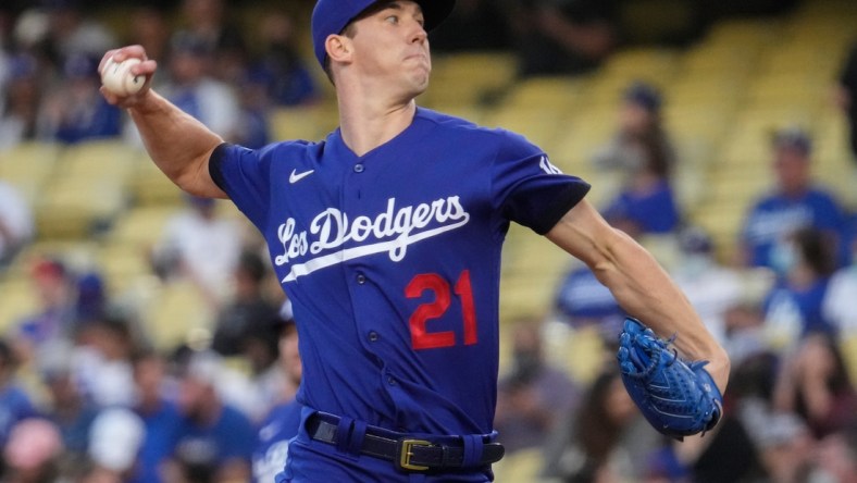 Aug 20, 2021; Los Angeles, California, USA; Los Angeles Dodgers starting pitcher Walker Buehler (21) throws a pitch during the first inning against the New York Mets at Dodger Stadium. Mandatory Credit: Robert Hanashiro-USA TODAY Sports