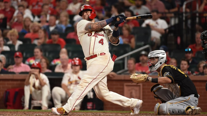 Aug 21, 2021; St. Louis, Missouri, USA; St. Louis Cardinals catcher Yadier Molina (4) hits an RBI single against the Pittsburgh Pirates during the sixth inning at Busch Stadium. Mandatory Credit: Joe Puetz-USA TODAY Sports