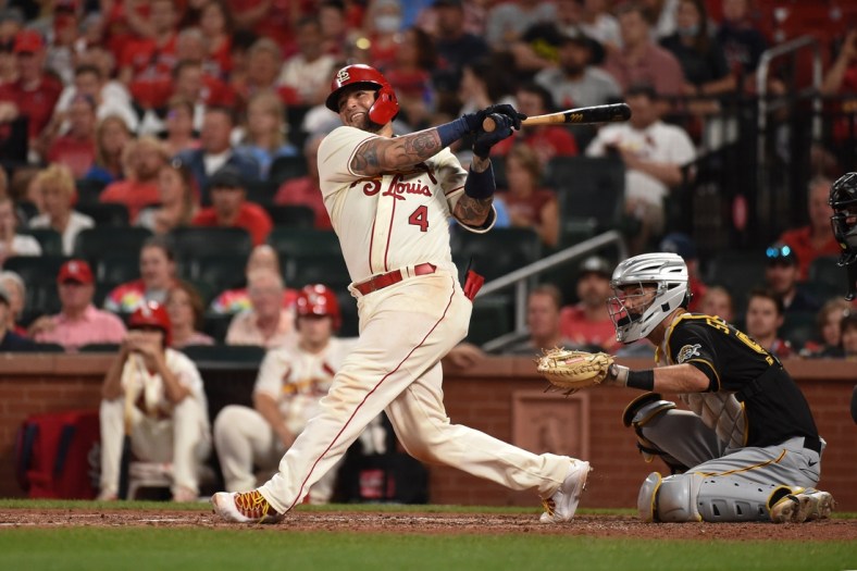 Aug 21, 2021; St. Louis, Missouri, USA; St. Louis Cardinals catcher Yadier Molina (4) hits an RBI single against the Pittsburgh Pirates during the sixth inning at Busch Stadium. Mandatory Credit: Joe Puetz-USA TODAY Sports