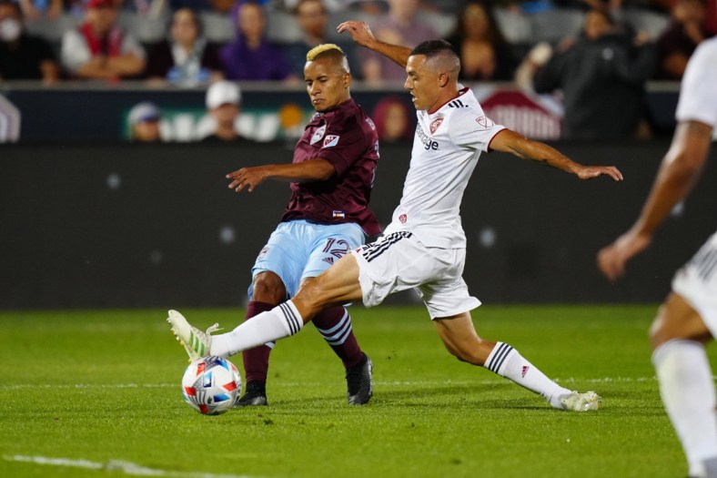 Aug 21, 2021; Commerce City, Colorado, USA; Colorado Rapids forward Michael Barrios (12) kicks the ball past Real Salt Lake defender Donny Toia (4) in the first half at Dick's Sporting Goods Park. Mandatory Credit: Ron Chenoy-USA TODAY Sports
