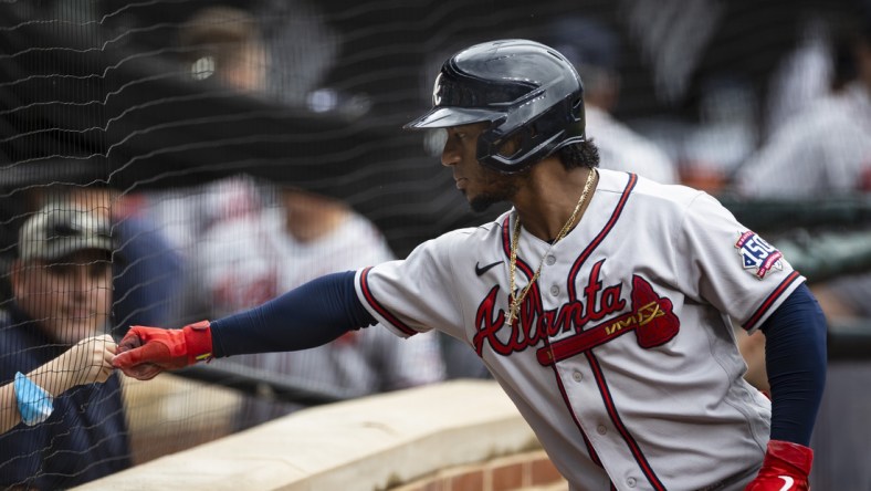 Aug 22, 2021; Baltimore, Maryland, USA; Atlanta Braves second baseman Ozzie Albies (1) first bumps a young fan during the first inning against the Baltimore Orioles at Oriole Park at Camden Yards. Mandatory Credit: Scott Taetsch-USA TODAY Sports