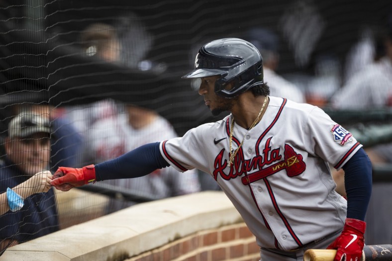 Aug 22, 2021; Baltimore, Maryland, USA; Atlanta Braves second baseman Ozzie Albies (1) first bumps a young fan during the first inning against the Baltimore Orioles at Oriole Park at Camden Yards. Mandatory Credit: Scott Taetsch-USA TODAY Sports