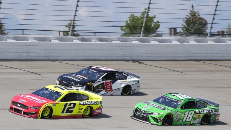 Aug 22, 2021; Brooklyn, Michigan, USA; NASCAR Cup Series driver Ryan Blaney (12), driver Tyler Reddick (8) and driver Kyle Busch (18) during the FireKeepers Casino 400 at Michigan International Speedway. Mandatory Credit: Mike Dinovo-USA TODAY Sports