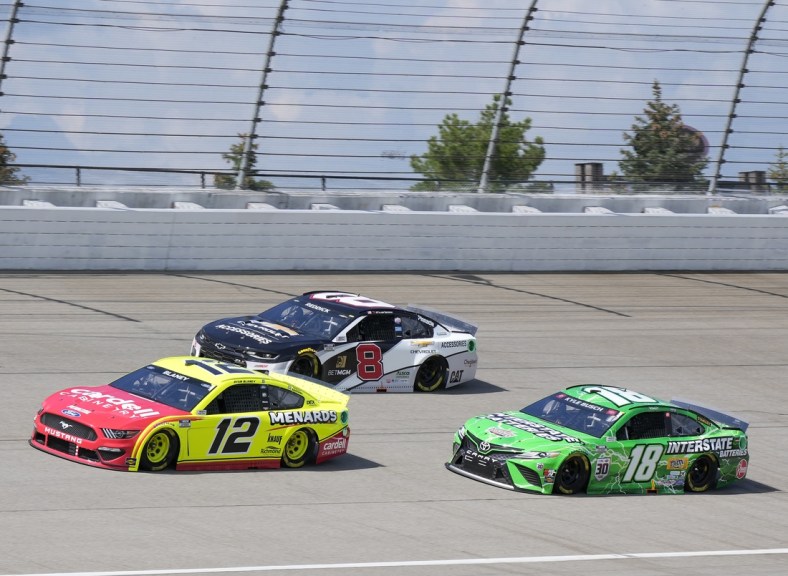 Aug 22, 2021; Brooklyn, Michigan, USA; NASCAR Cup Series driver Ryan Blaney (12), driver Tyler Reddick (8) and driver Kyle Busch (18) during the FireKeepers Casino 400 at Michigan International Speedway. Mandatory Credit: Mike Dinovo-USA TODAY Sports
