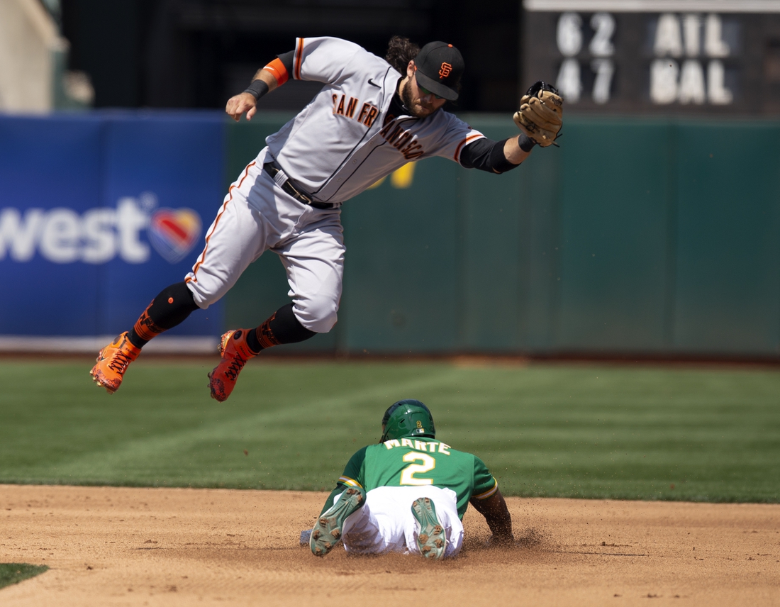 Aug 22, 2021; Oakland, California, USA; Oakland Athletics center fielder Starling Marte (2) slides safely into second with a stolen base as San Francisco Giants shortstop Brandon Crawford (35) has to leave his feet to corral the relay during the fourth inning at RingCentral Coliseum. Mandatory Credit: D. Ross Cameron-USA TODAY Sports