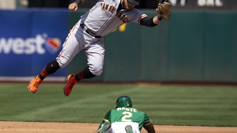 Aug 22, 2021; Oakland, California, USA; Oakland Athletics center fielder Starling Marte (2) slides safely into second with a stolen base as San Francisco Giants shortstop Brandon Crawford (35) has to leave his feet to corral the relay during the fourth inning at RingCentral Coliseum. Mandatory Credit: D. Ross Cameron-USA TODAY Sports