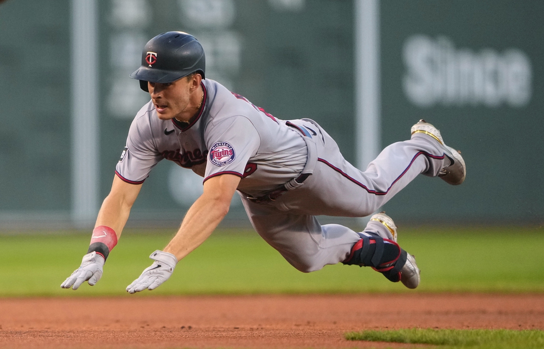 Aug 24, 2021; Boston, Massachusetts, USA;  Minnesota Twins right fielder Max Kepler (26) dives into third base with a triple during the first inning against the Boston Red Sox at Fenway Park. Mandatory Credit: Gregory Fisher-USA TODAY Sports