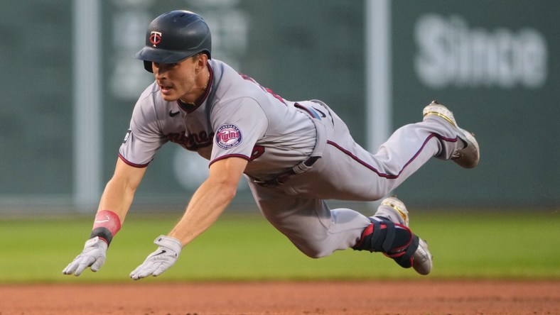 Aug 24, 2021; Boston, Massachusetts, USA;  Minnesota Twins right fielder Max Kepler (26) dives into third base with a triple during the first inning against the Boston Red Sox at Fenway Park. Mandatory Credit: Gregory Fisher-USA TODAY Sports