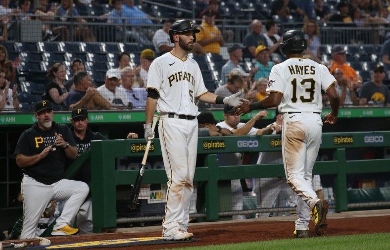 Aug 24, 2021; Pittsburgh, Pennsylvania, USA; Pittsburgh Pirates catcher Jacob Stallings (58) congratulates third baseman Ke'Bryan Hayes (13) after Hayes scored a run against the Arizona Diamondbacks during the third inning at PNC Park. Mandatory Credit: Charles LeClaire-USA TODAY Sports