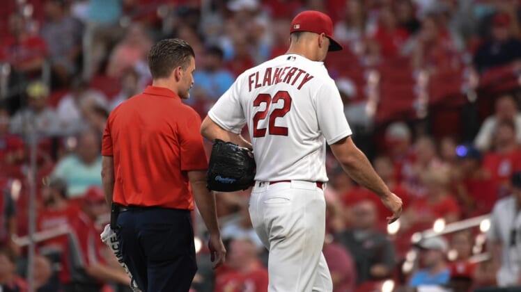 Aug 24, 2021; St. Louis, Missouri, USA; St. Louis Cardinals starting pitcher Jack Flaherty (22) leaves the field with a trainer after being pulled from the game against the Detroit Tigers during the third inning at Busch Stadium. Mandatory Credit: Joe Puetz-USA TODAY Sports