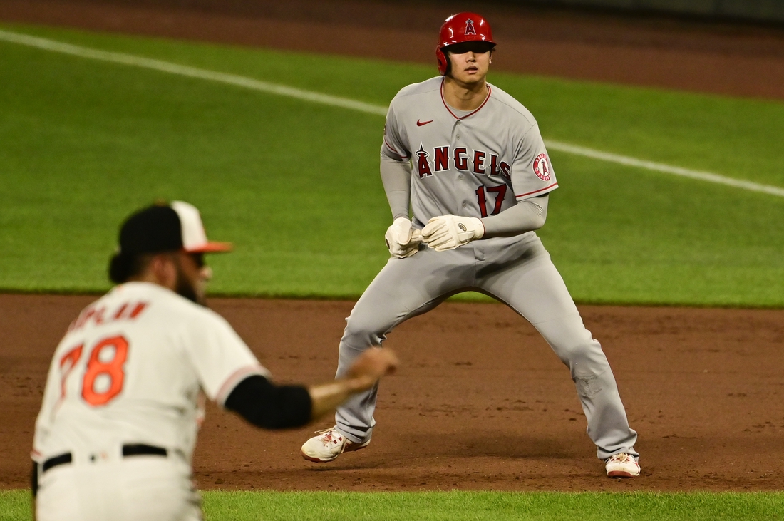 Aug 24, 2021; Baltimore, Maryland, USA;  Los Angeles Angels designated hitter Shohei Ohtani (17) leads from first base as Baltimore Orioles relief pitcher Marcos Diplan (78) delivers pitch in the eighth inning at Oriole Park at Camden Yards. Mandatory Credit: Tommy Gilligan-USA TODAY Sports