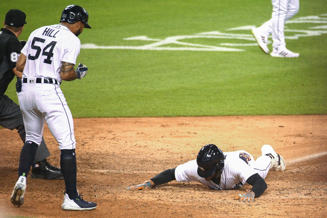 Aug 27, 2021; Detroit, Michigan, USA; Detroit Tigers center fielder Victor Reyes (22) slides into home after a in the park home run during the eighth inning against the Toronto Blue Jays at Comerica Park. Mandatory Credit: Tim Fuller-USA TODAY Sports