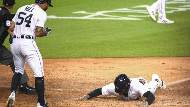 Aug 27, 2021; Detroit, Michigan, USA; Detroit Tigers center fielder Victor Reyes (22) slides into home after a in the park home run during the eighth inning against the Toronto Blue Jays at Comerica Park. Mandatory Credit: Tim Fuller-USA TODAY Sports