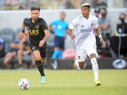 Aug 28, 2021; Los Angeles, CA, Los Angeles, CA, USA; Los Angeles FC forward Diego Rossi (9) moves the ball against Los Angeles Galaxy defender Julian Araujo (2) during the second half at Banc of California Stadium. Mandatory Credit: Gary A. Vasquez-USA TODAY Sports