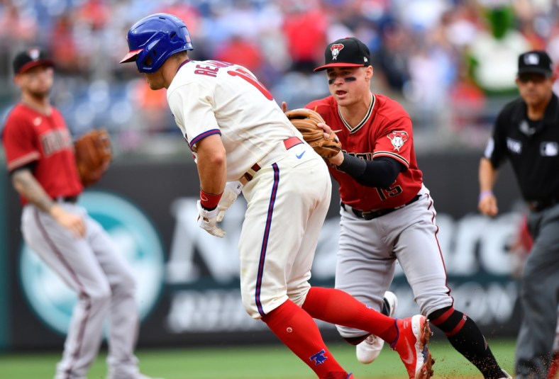 Aug 29, 2021; Philadelphia, Pennsylvania, USA; Arizona Diamondbacks second baseman Andrew Young (15) tags out Philadelphia Phillies first baseman J.T. Realmuto (10) in a rundown in the third inning at Citizens Bank Park. Mandatory Credit: Kyle Ross-USA TODAY Sports