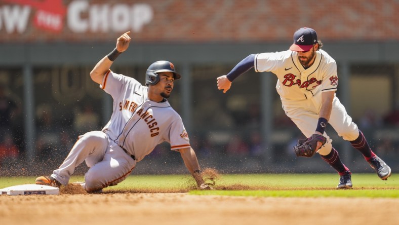 Aug 29, 2021; Cumberland, Georgia, USA; San Francisco Giants right fielder LaMonte Wade Jr. (31) steals second base ahead of a tag by Atlanta Braves shortstop Dansby Swanson (7) during the third inning at Truist Park. Mandatory Credit: Dale Zanine-USA TODAY Sports