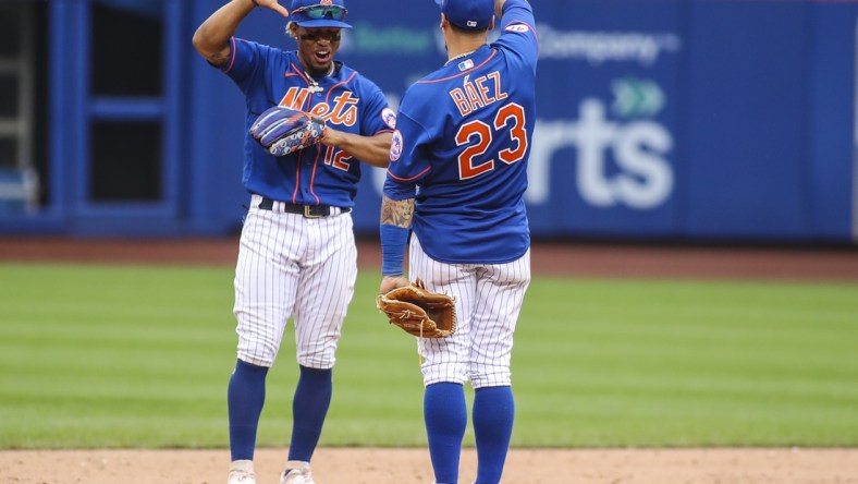 Aug 29, 2021; New York City, New York, USA; New York Mets shortstop Francisco Lindor (12) and second baseman Javier Baez (23) celebrate after defeating the Washington Nationals 9-4 at Citi Field. Mandatory Credit: Wendell Cruz-USA TODAY Sports