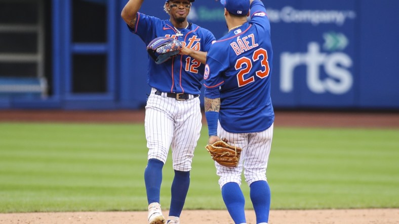 Aug 29, 2021; New York City, New York, USA; New York Mets shortstop Francisco Lindor (12) and second baseman Javier Baez (23) celebrate after defeating the Washington Nationals 9-4 at Citi Field. Mandatory Credit: Wendell Cruz-USA TODAY Sports