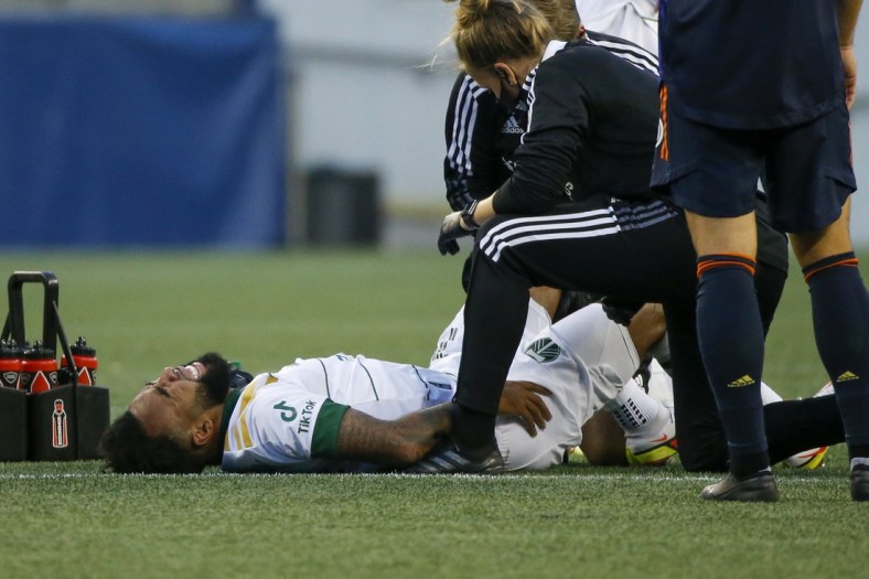 Aug 29, 2021; Seattle, Washington, USA; Portland Timbers midfielder Eryk Williamson (19) reacts after suffering a leg injury during the first half against the Seattle Sounders FC at Lumen Field. Mandatory Credit: Joe Nicholson-USA TODAY Sports