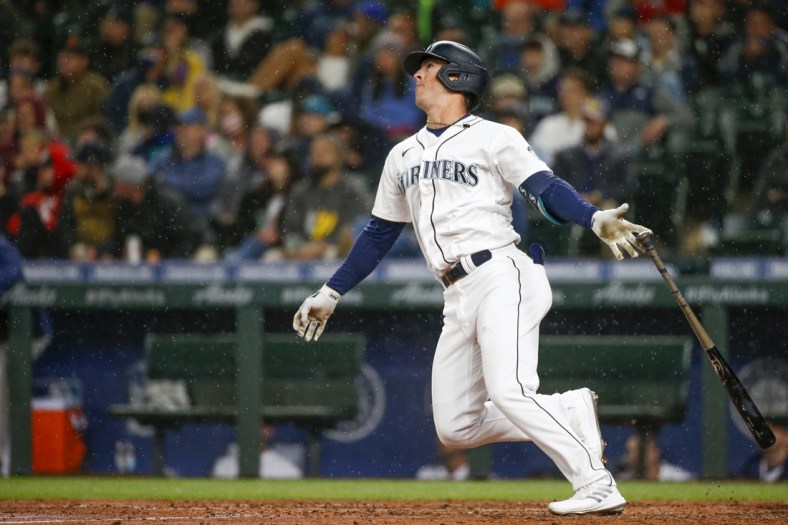 Aug 30, 2021; Seattle, Washington, USA; Seattle Mariners pinch hitter Dylan Moore (25) hits a two-run home against the Houston Astros during the sixth inning at T-Mobile Park. Mandatory Credit: Joe Nicholson-USA TODAY Sports