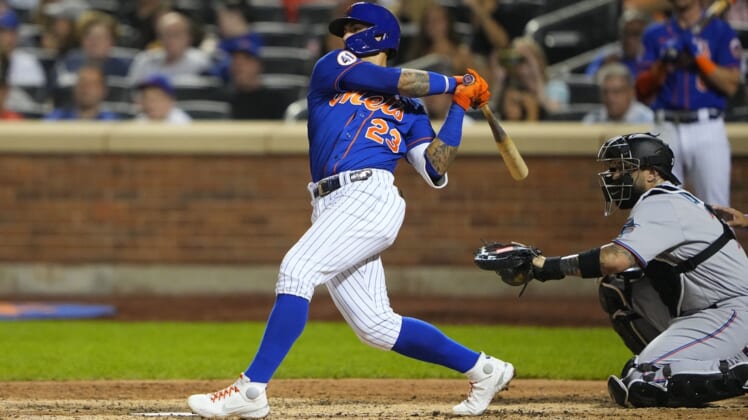 Aug 31, 2021; New York City, New York, USA; New York Mets shortstop Javier Baez (23) hits a single against the Miami Marlins during the fourth inning at Citi Field. Mandatory Credit: Gregory Fisher-USA TODAY Sports