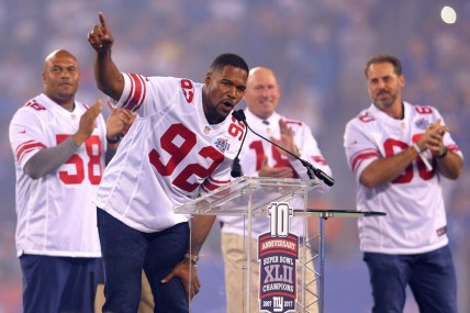 Sep 18, 2017; East Rutherford, NJ, USA; Former New York Giants player Michael Strahan speaks in front of former players Antonio Pierce (58) and Jeff Feagles (18) and Shaun O'Hara (60) during a halftime ceremony honoring the 2007 Super Bowl champion Giants during a game against the Detroit Lions at MetLife Stadium. Mandatory Credit: Brad Penner-USA TODAY Sports