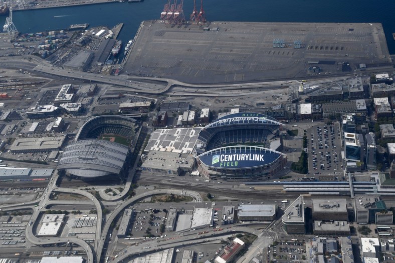 Aug 29, 2019; Seattle, WA, USA; General overall aerial view of T-Mobile Park (left) and CenturyLink Field. The retractable roof T-Mobile Park, opened in 1999 and formerly known as Safeco Field, is the home of the Seattle Mariners of the MLB. CenturyLink Field was opened in 2002 and was named Seahawks Stadium (2002-2004) and Qwest Field (2004-11). It is the home of the Seattle Seahawks of the NFL and Seattle Sounders of the MLS.Mandatory Credit: Kirby Lee-USA TODAY Sports