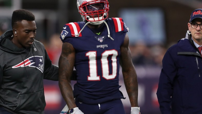 Oct 10, 2019; Foxborough, MA, USA; New England Patriots wide receiver Josh Gordon (10) is helped off of the field during the first half against the New York Giants at Gillette Stadium. Mandatory Credit: Paul Rutherford-USA TODAY Sports