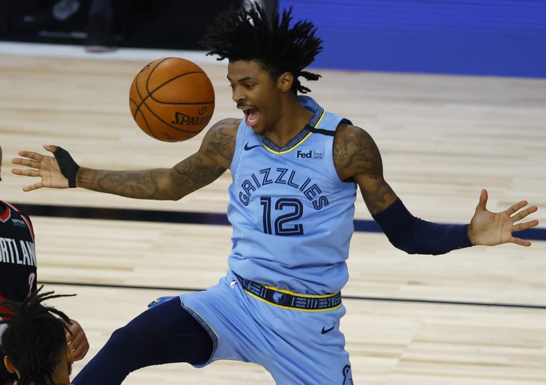 Aug 15, 2020; Lake Buena Vista, Florida, USA; Ja Morant #12 of the Memphis Grizzlies reacts after a dunk against the Portland Trail Blazers during the fourth quarter in the Western Conference play-in game one at The Field House. Mandatory Credit: Kevin C. Cox/Pool Photo-USA TODAY Sports