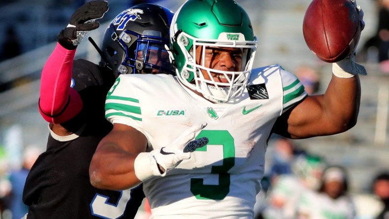 North Texas running back DeAndre Torrey (3) reaches out to make a touchdown as MTSU safety Gregory Grate Jr. (3) tackles him on Saturday, Oct. 17, 2020, during the Blackout game at MTSU.

29 Mtsu V North Texas