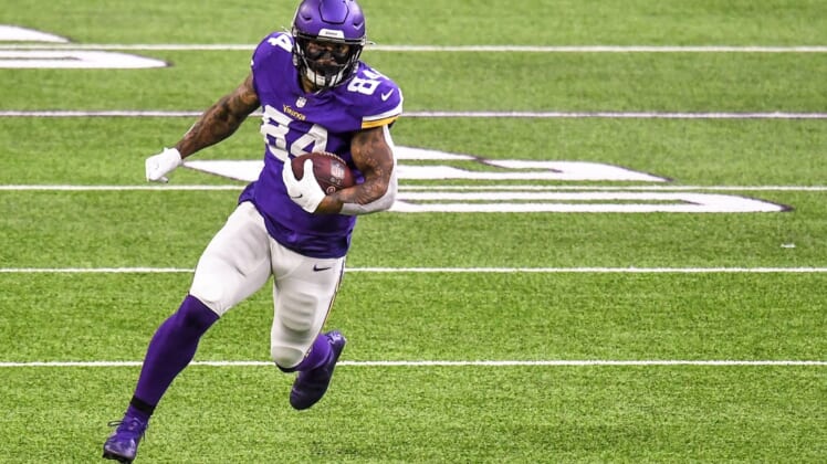 Oct 18, 2020; Minneapolis, Minnesota, USA;  Minnesota Vikings tight end Irv Smith Jr. (84) runs with the ball after a catch for a 36-yard gain in the first quarter against the Atlanta Falcons at U.S. Bank Stadium. Mandatory Credit: Nick Wosika-USA TODAY Sports